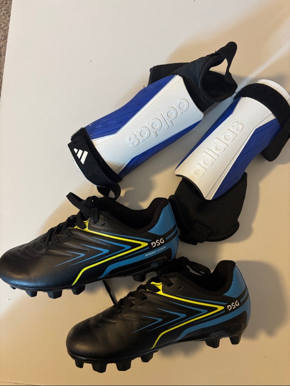 Adidas shin guards and DSG Soccer Cleats with Yellow Accents and White